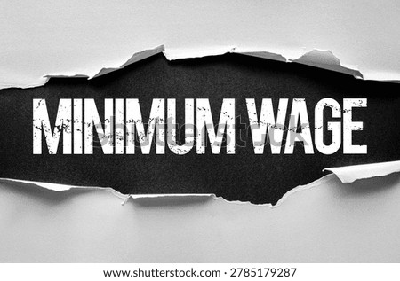Minimum Wage is shown in a bold, worn-out typeface behind torn paper edges, delivering a gritty and impactful visual that reflects socio-economic themes, urgency, and advocacy for workers' rights
