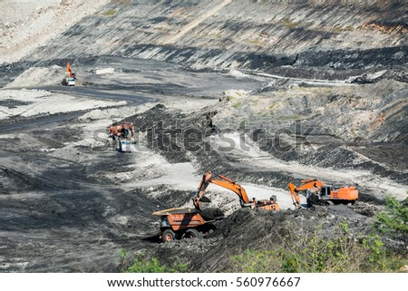 Mining dump trucks working in coalmine , Used as a source of electricity generation in the country.
