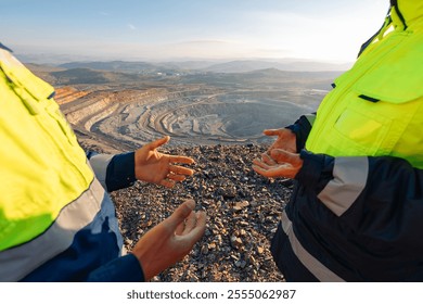 Mining Engineers Discuss Operations at Open Pit Quarry overlooking ore mine.