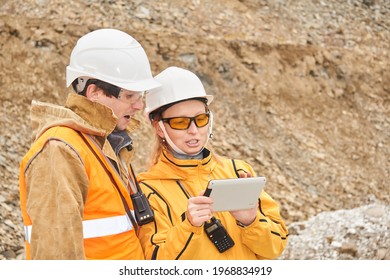 mining engineers discussing working documentation outdoor at the mining site