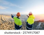 Mining Engineers worker on Open Pit Quarry overlooking ore mine, back view.