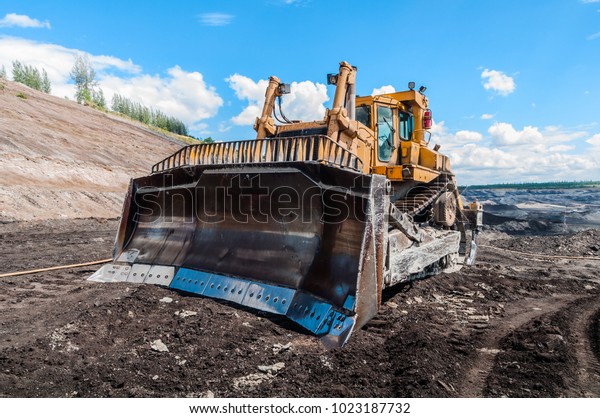 Mining Equipment or Mining\
Machinery, Bulldozer, wheel loader, shovels, loading of coal, ore\
on the dump truck from open-pit or open-cast mine as the Coal\
Production.