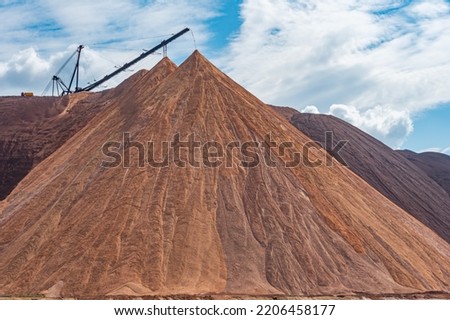 Mining industry close up. Telestacker handles the ore closeup for potash waste heaps, extraction of salt and potash fertilizers in a quarry and processing of ore