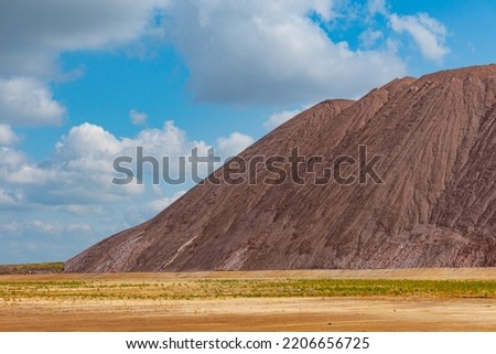 Mining industry close up. Telestacker handles the ore closeup for potash waste heaps, extraction of salt and potash fertilizers in a quarry and processing of ore