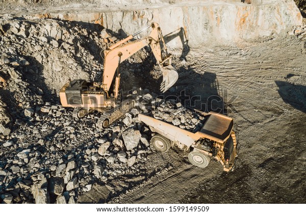 Mining machinery working
over rocks.