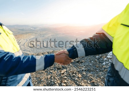 Mining Partnership: Engineers Collaborating in Open Pit Mine Landscape.