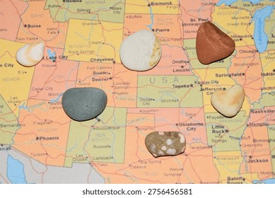 Mining. Small pieces of various types of rock mined in America on a map of America.