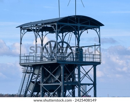 The mining tower. Steel construction of the tower, control of the mining lift. Aerial view, spring time, blue sky. Barbora Mine, Karvina, Czech Republic. 