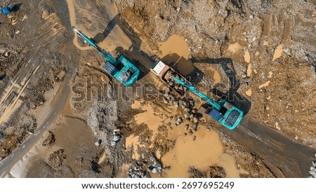 Mining Work of Excavators and Dump Trucks in Rock and Sand Quarry, mining site view from above