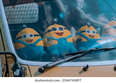 Minion dolls displayed on the dashboard of a truck that look attractive show that the owner or driver of the truck has a cheerful character and likes to work hard like the minion character