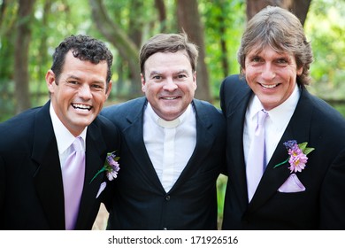 Minister Posing With A Handsome Gay Wedding Couple He Has Just Married.  *focus Is On The Minister.