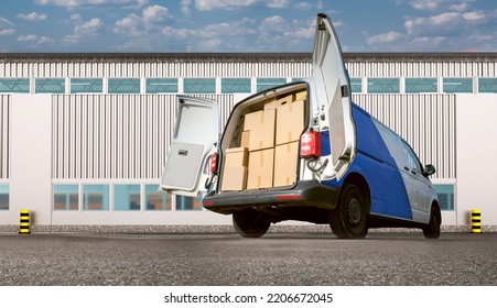 Minivan With Cardboard Boxes. Van For Move. Delivery Service Van Back View. Boxes For Moving In Truck. Courier Van With Open Rear Doors. Courier Service Car. Minivan Parked In Front Of Hangar