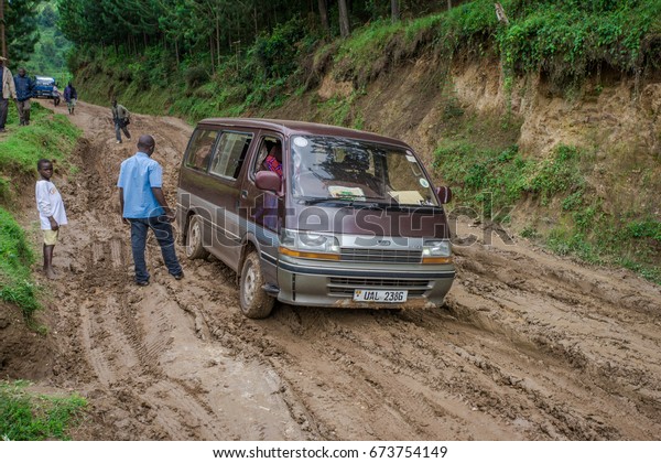 Minivan stuck in the\
mud on a Rural road in southwestern Uganda, at the Bwindi\
Impenetrable Forest National Park, at the borders of Uganda, Congo\
and Rwanda, circa October\
2012
