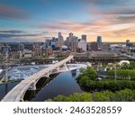 Minneapolis, Minnesota, USA downtown city skyline over the river at dusk.