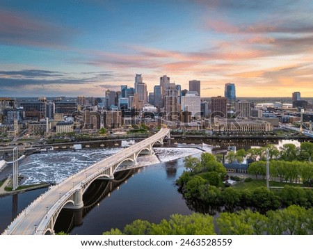 Minneapolis, Minnesota, USA downtown city skyline over the river at dusk.