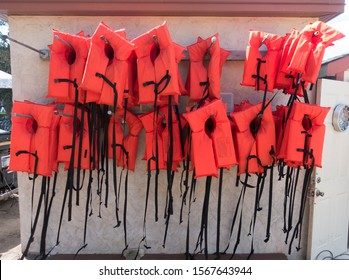 MINNEAPOLIS, MINNESOTA / USA - JUNE 26, 2017: Array of angry orange life preservers floatation devices at the boat rental area near the Lake Calhoun Pavilion. 