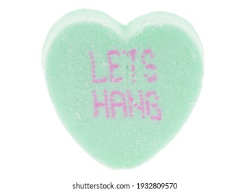 MINNEAPOLIS, MINNESOTA, USA - NOVEMBER 21, 2020 - Green heart with red letters.  Valentine tiny conversation sugar heart - let's hang - macro extreme detail for Valentine's Day