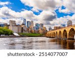 Minneapolis, Minnesota, USA on a beautiful day with the downtown city skyline on the Mississippi River.