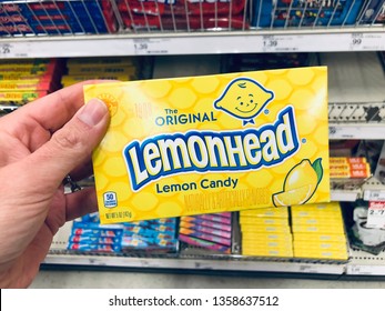 Minneapolis, MN - April 3, 2019: Caucasian Woman Shopper's Hand Holds Up A Movie Theater Size Box Of Lemonhead Brand Candy At A Grocery Store