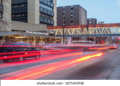 MINNEAPOLIS, MN - DECEMBER 2020 - A Blue Hour Long Exposure Shot Of Street Traffic Blurring Past The Hennepin County Medical Center In Downtown Minneapolis