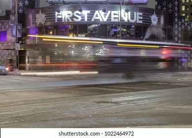 MINNEAPOLIS, MN - FEBRUARY 2018 -A Medium Close Up Wide Angle Night Long Exposure Shot Of A Bus Passing Downtown Minneapolis' First Avenue Music Venue