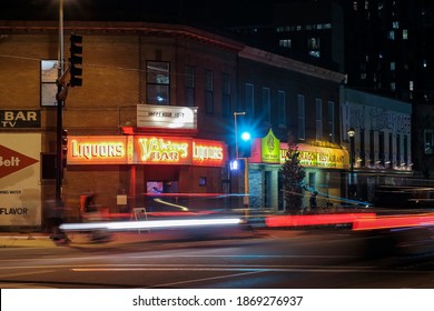 MINNEAPOLIS, MN - JULY 2016 - A Nighttime Long Exposure Shot Of Traffic Blurring Past Of Iconic Viking Bar, Lucky Dragon, And Hard Times Cafe In The Cedar-Riverside Neighborhood Of Minneapolis