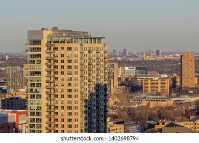 MINNEAPOLIS, MN - MARCH 2018 - A Shot Of Sunset Light Over Minneapolis Apartment Buildings And Distant St. Paul Skyline