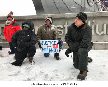 Minneapolis, MN/USA- January 14, 2018- Protesters kneel down in front of the Vikings Playoff Game at US Bank Stadium in a National Anthem protest.