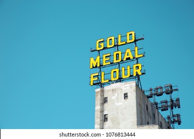 MINNEAPOLIS-MINNESOTA, APRIL 1, 2018:   Arguably one of the most iconic riverfront sights in Minneapolis, the twin Gold Medal Flour signs were built in 1910.   The sign is part of a vibrant riverfront