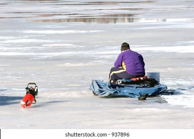 A Minnesota Man Ice Fishing On Lake Nokomis