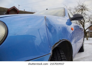 Minor Accident In A Car, In Winter A Car With A Dent In The Wing