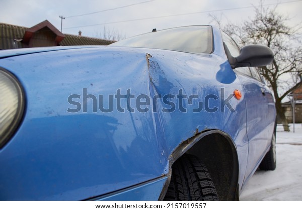 minor accident in a car, in winter a car with a dent\
in the wing