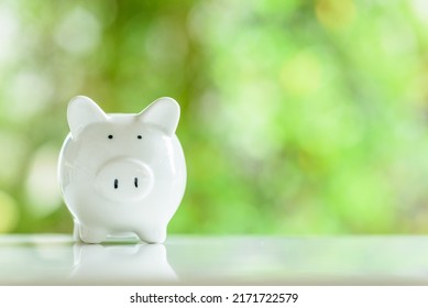 Minor children savings account, financial concept : White ceramic piggy bank on a table, depicts a type of saving account deposit for child education, allow deposit money from kids for brighter future - Shutterstock ID 2171722579