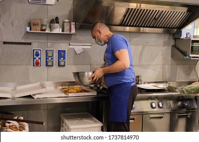 Minori,Sa,Italy - May 21,2020 :The Owner Of A Deli And Pizzeria To Take Away In His Premises To The Reopening Of The Commercial Activity . Preparation Of A Pizza Before Delivery.