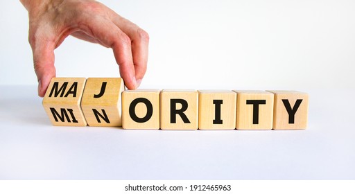 Minority Or Majority Symbol. Businessman Turns A Cube And Changes The Word 'minority' To 'majority'. Beautiful White Background. Minority Or Majority And Business Concept. Copy Space.