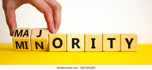 Minority Or Majority Symbol. Businessman Turns Wooden Cubes And Changes The Word 'minority' To 'majority'. Beautiful White Background. Minority Or Majority And Business Concept. Copy Space.