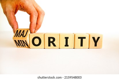 Minority or majority symbol. Businessman turns wooden cubes and changes the concept word Minority to Majority. Beautiful white background. Minority or majority and business concept. Copy space.