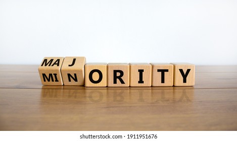 Minority or majority symbol. Turned wooden cubes and changed the word 'minority' to 'majority'. Beautiful wooden table, white background. Minority or majority and business concept. Copy space.