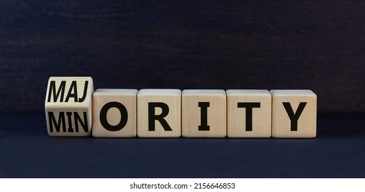 Minority or majority symbol. Turned wooden cubes and changed the concept word Minority to Majority. Beautiful black table black background. Minority or majority and business concept. Copy space.