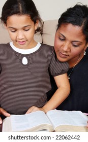 Minority Woman And Her Daughter Reading The Bible