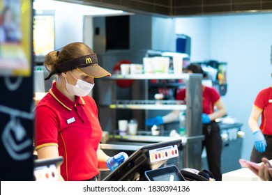 Minsk, Belarus 03.10.2020: McDonald's Employee At The Cash Register Wearing A Mask And Gloves During A Pandemic