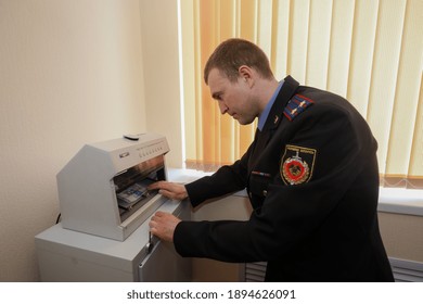 MINSK, BELARUS - 1 OCTOBER, 2020: Criminologist Examines Counterfeit Bills