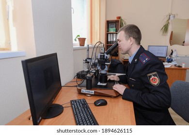 MINSK, BELARUS - 1 OCTOBER, 2020: Criminologist Examines Counterfeit Bills