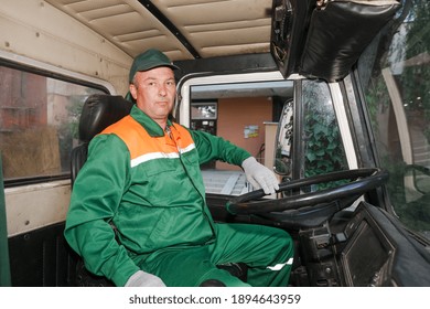 MINSK, BELARUS - 1 OCTOBER, 2020: Garbage Truck Driver Unloads Garbage From A Container Into A Car