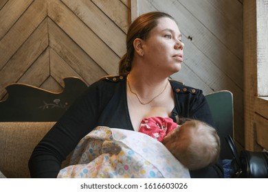 MINSK, BELARUS - 1 OKTOBER, 2019: Mom Breastfeeds Her Baby In A Cafe