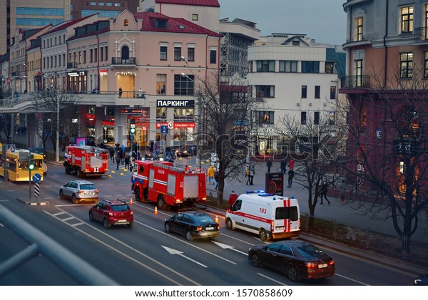 Minsk, Belarus. 23 Nov 2019. Three fire trucks and\
emergency van conduct  rescue operation in the city to save people\
and eliminate the fire. Firefighter pumper trucks responding to a\
emergency call