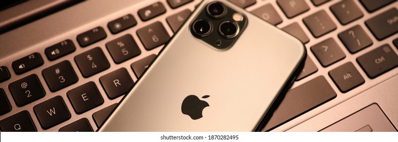 Minsk, Belarus - 30 July 2020 : New Model Apple Iphone Lies On Laptop Keyboard Closeup.