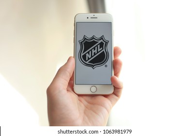 MINSK, BELARUS – April 07, 2018: Woman holding brand new white Apple iPhone 7. The logo of the brand "NHL National Hockey League".