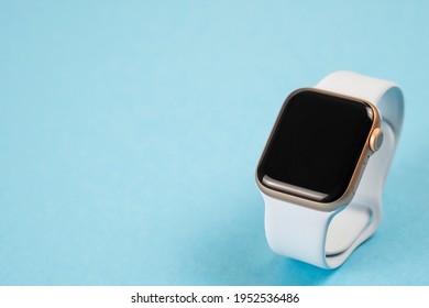 Minsk, Belarus - April 09, 2021: Apple Watch With Blue Strap On Color Background. Copy Space