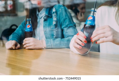 MINSK, BELARUS - APRIL, 2017: Two woman relaxing with pepsi in the cafe